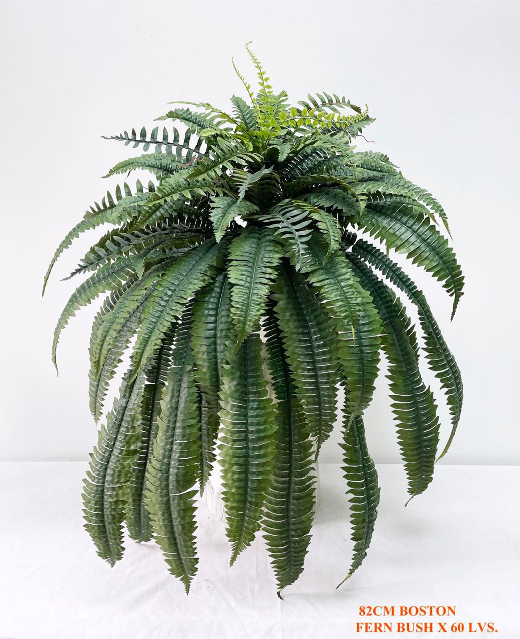 An artificial Boston Fern Bush with 60 leaves, measuring 82cm in height, displayed against a plain white background.