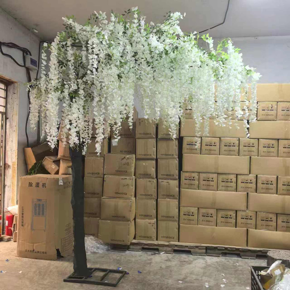 Artificial wisteria tree arrangement on a stand in warehouse ready to be shipped for an event