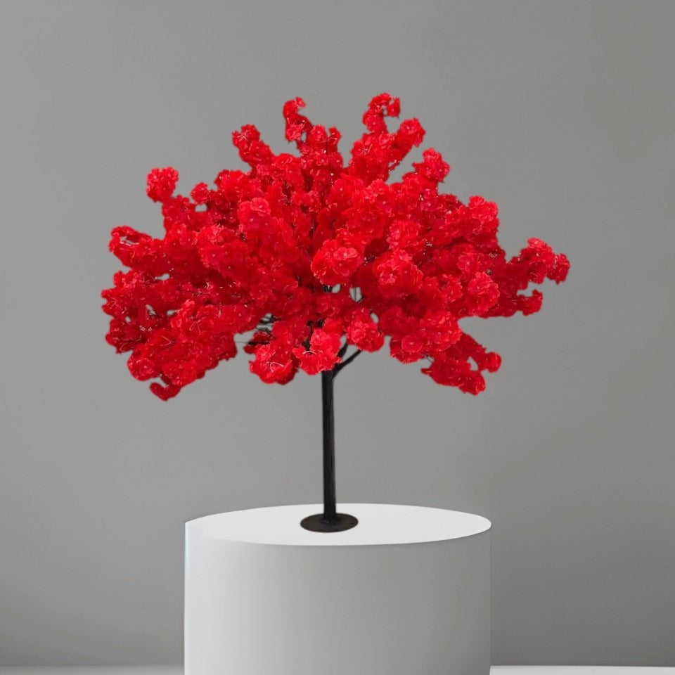 4ft artificial cherry blossom tree in red color with dense silk flowers and black textured trunk, standing in a black nursery pot inside a modern living room