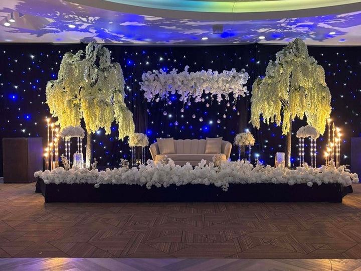 tall artificial wisteria setup at wedding stage adding elegance and beauty to the event.