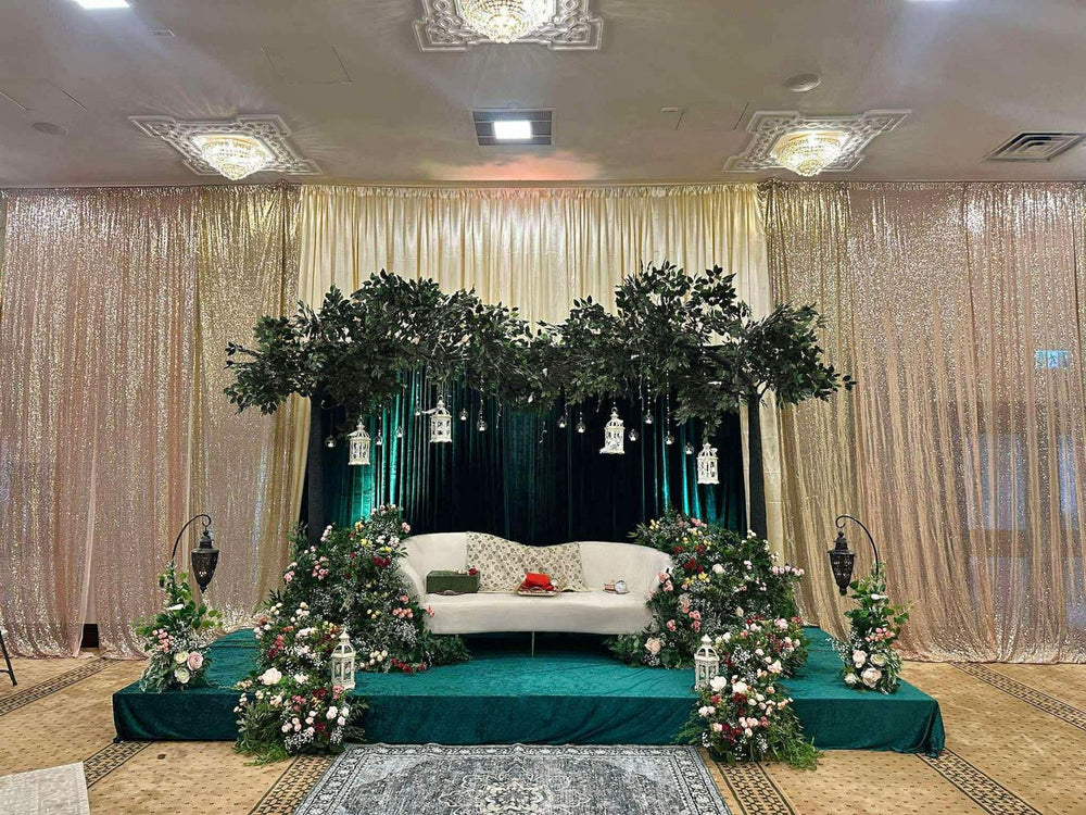 10ft arch ficus tree in a Toronto wedding venue with white aisle decorations and a gold curtain backdrop