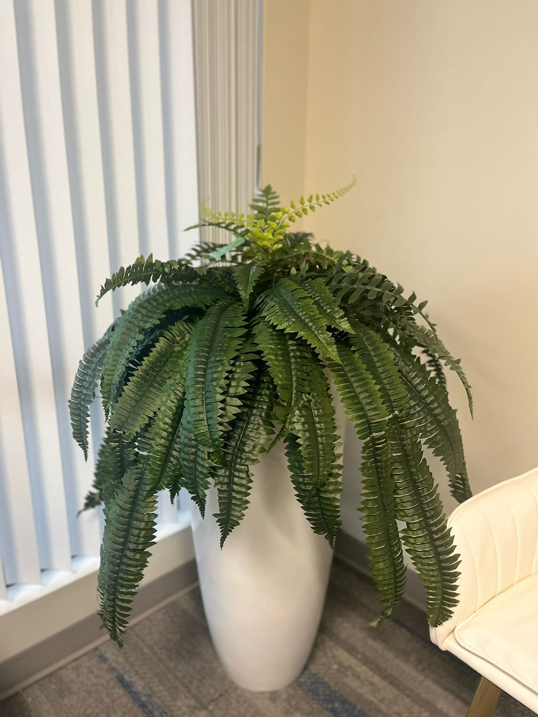 Artificial Boston fern bush 82cm with dense green foliage displayed in a large planter.