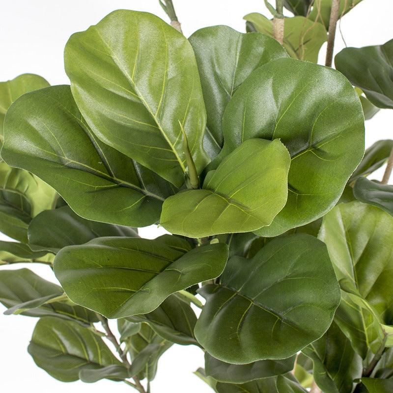 Close-up of large, vibrant green fiddle-leaf fig leaves, showcasing their realistic texture and natural veining. The leaves are broad and lush, adding to the plant's lifelike appearance.