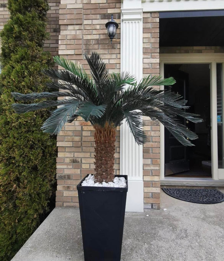 Outdoor artificial palm tree in a modern black planter, perfect for adding a tropical touch to patios, porches, or garden spaces.