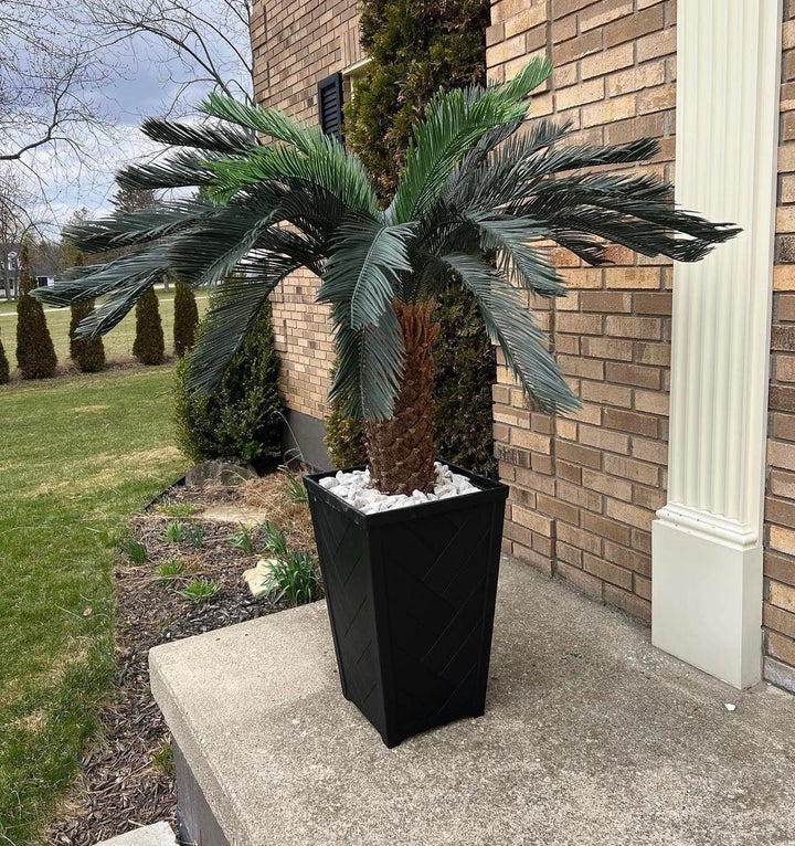 Outdoor artificial palm tree in a modern black planter, perfect for adding a tropical touch to patios, porches, or garden spaces.