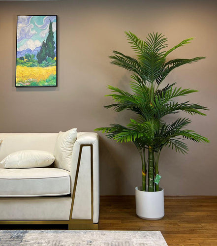 Realistic artificial plant in a white pot, perfect for adding a touch of greenery to any indoor space