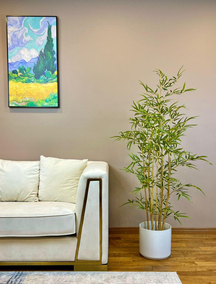 Stylish artificial bamboo plant in a white pot, ideal for enhancing indoor spaces with a touch of natural elegance.