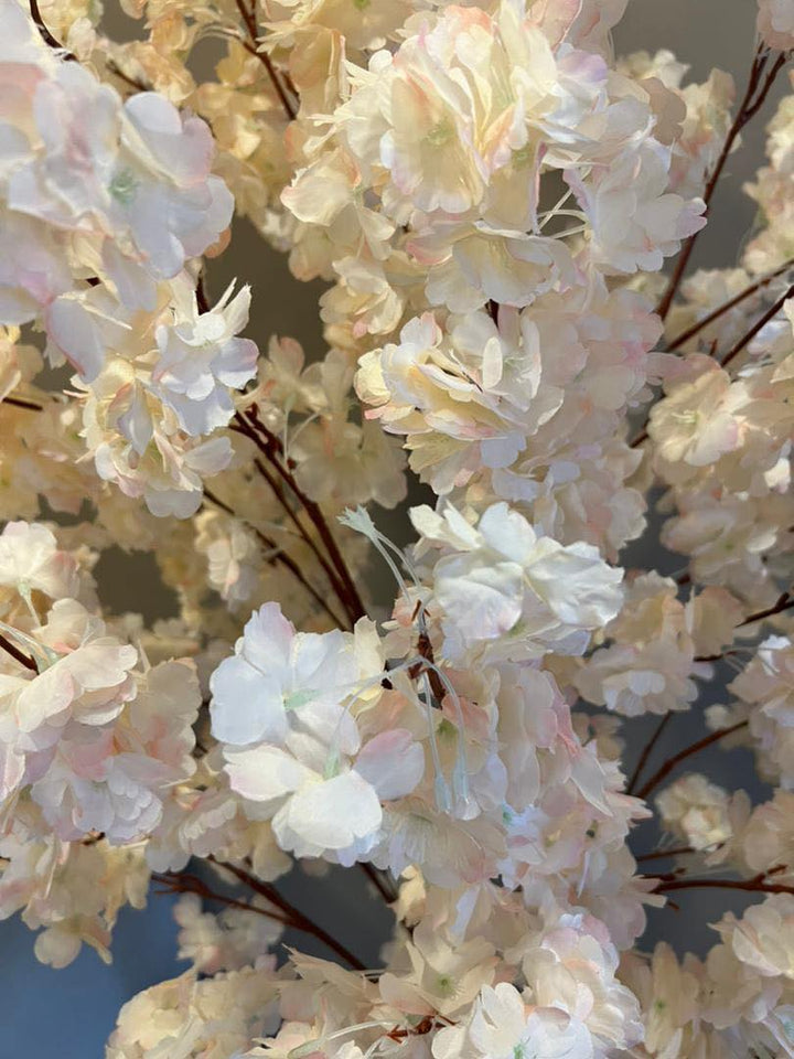 Detailed view of artificial cherry blossom petals in soft pastel shades, capturing the delicate beauty and intricate design, perfect for adding a touch of natural elegance to any space.