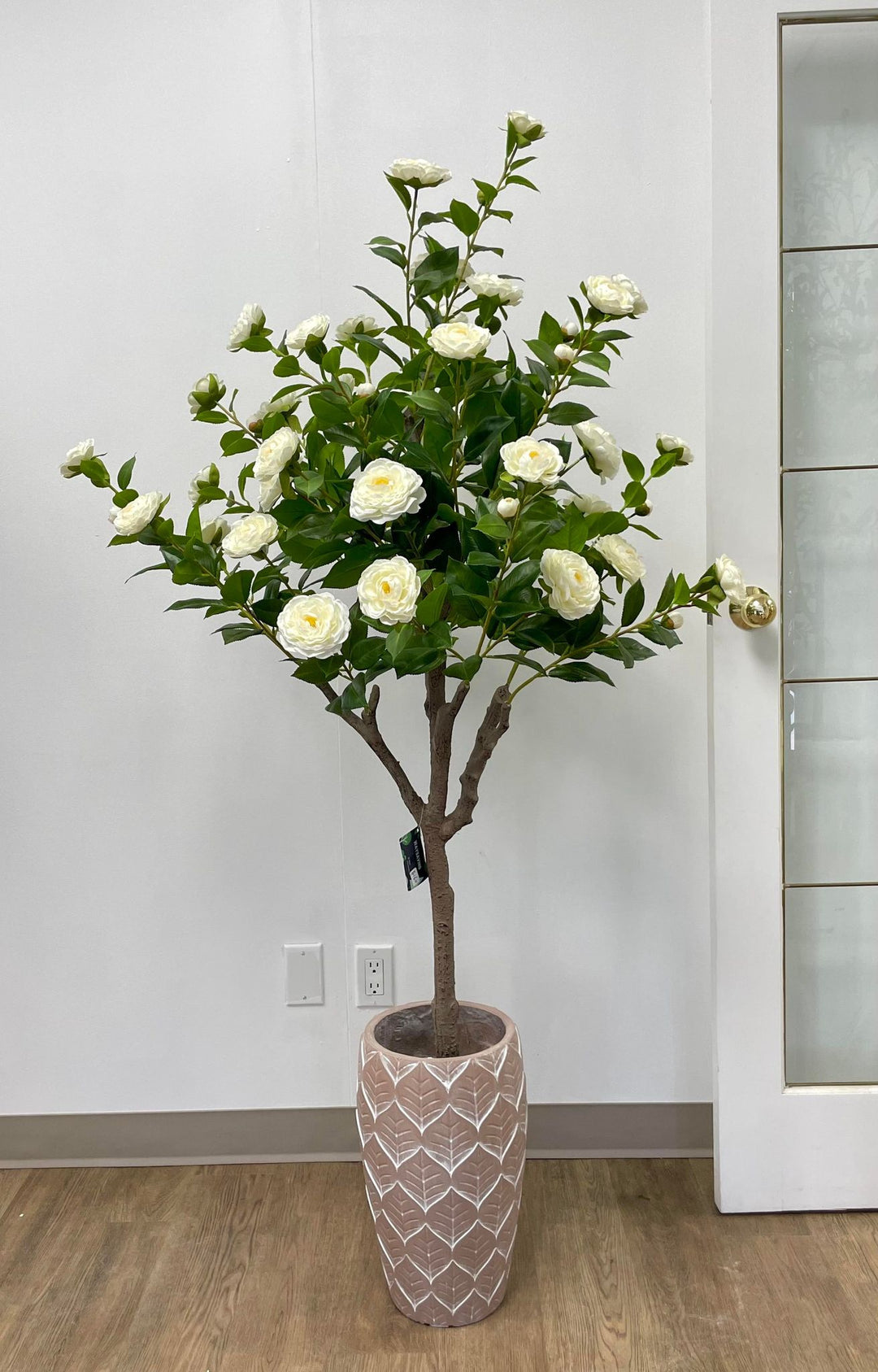 Artificial white flower arrangement in a decorative patterned pot, perfect for enhancing the aesthetics of any room
