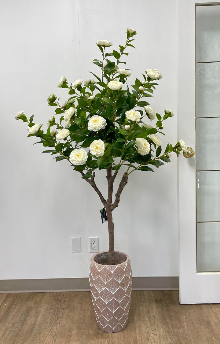 Artificial white flower arrangement in a decorative patterned pot, perfect for enhancing the aesthetics of any room