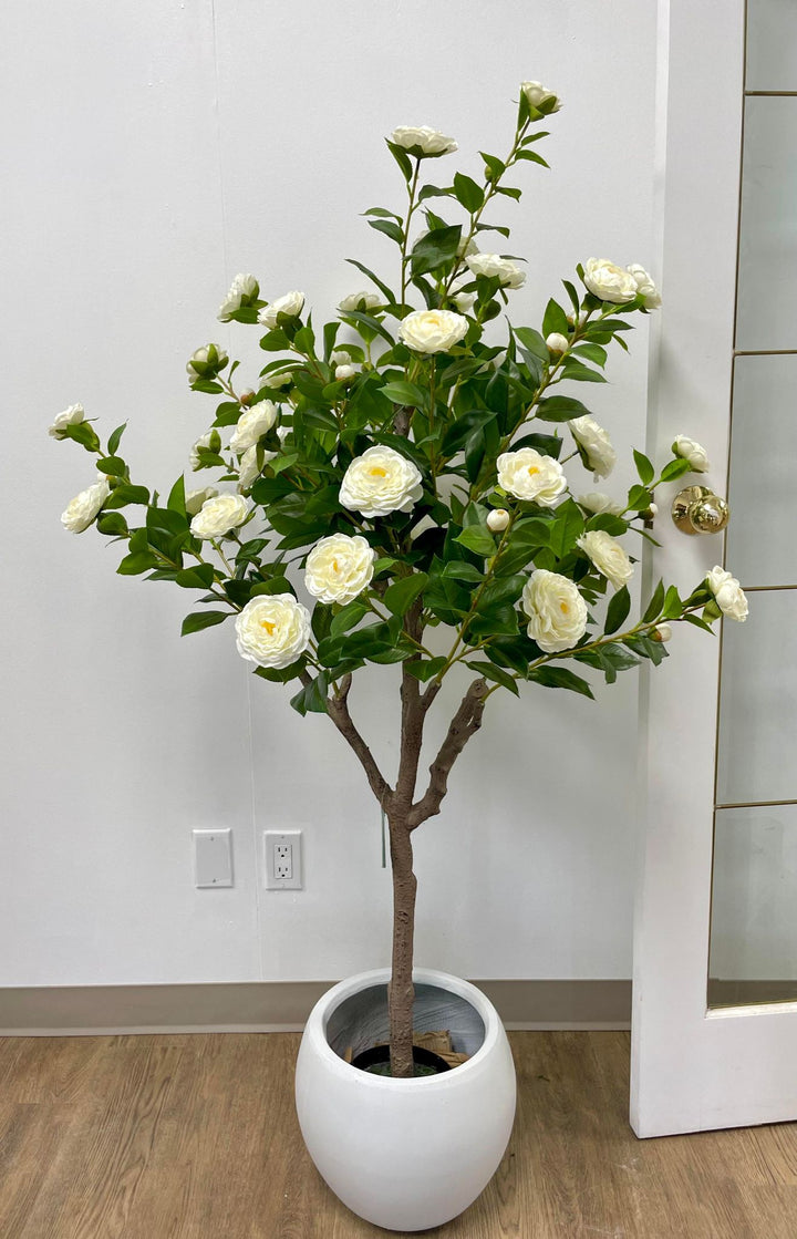 Elegant artificial white flowers in a modern pot, ideal for adding a touch of natural beauty to any indoor space.