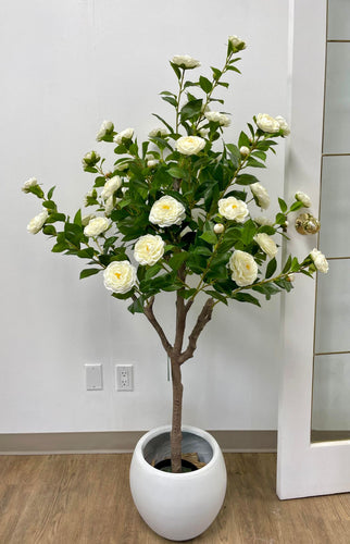 Elegant artificial white flowers in a modern pot, ideal for adding a touch of natural beauty to any indoor space.