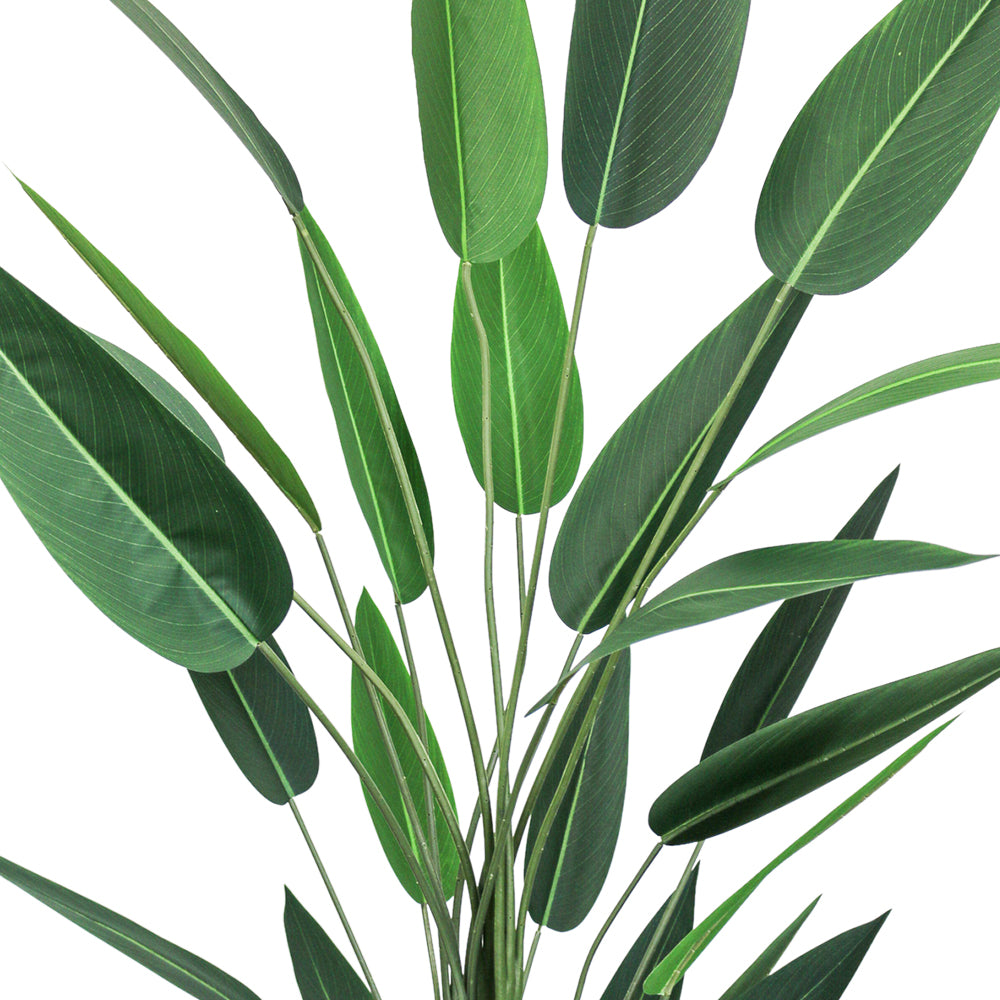 Close-up view of a large 7ft artificial bird of paradise plant, featuring multiple elongated green leaves with detailed veining, arranged in a natural, upward pattern against a white background.