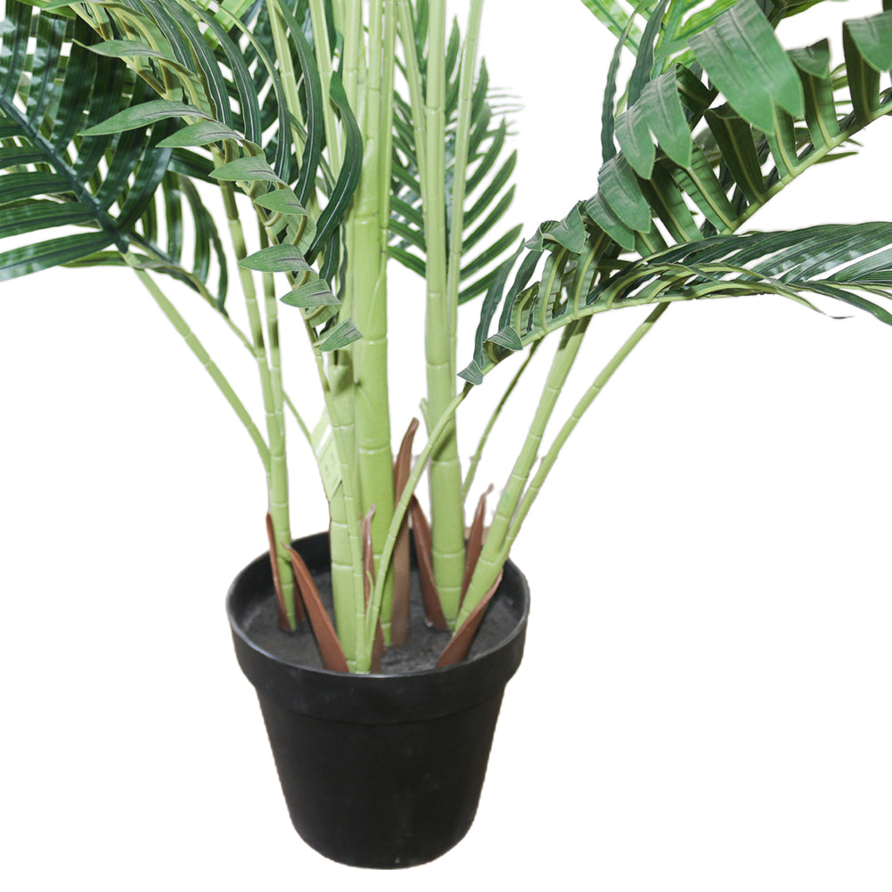 Close-up of the base of an artificial palm tree in a black pot, featuring green stems and leaves designed to look like a natural palm.