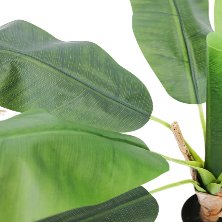 Close-up of large artificial banana leaves with realistic texture, highlighting the natural appearance of the plant, ideal for tropical-themed indoor decor.