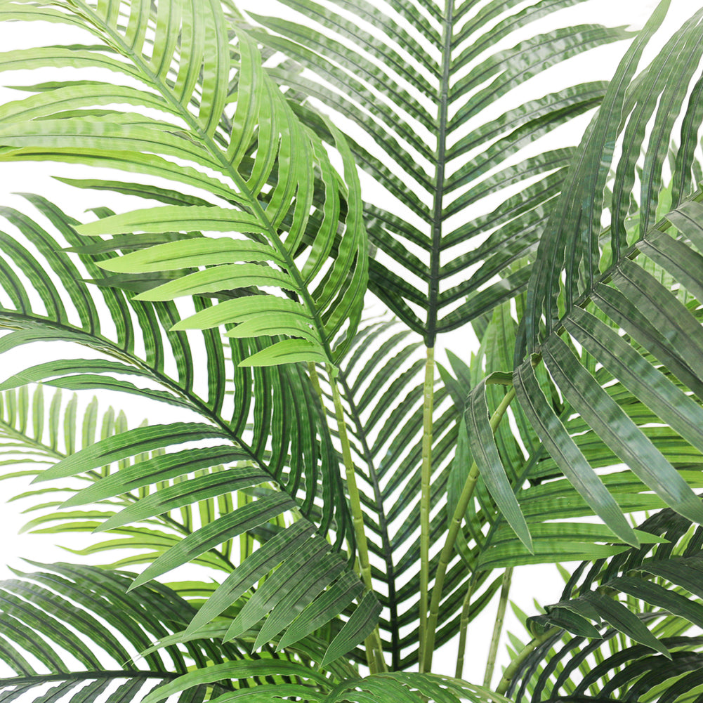 Close-up of artificial palm fronds, showcasing vibrant green leaves and realistic detailing, ideal for indoor decoration.