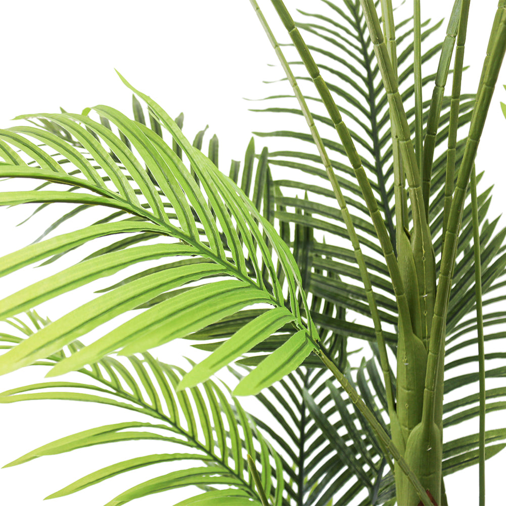 Close-up of artificial palm fronds, showcasing vibrant green leaves and realistic detailing, ideal for indoor decoration.