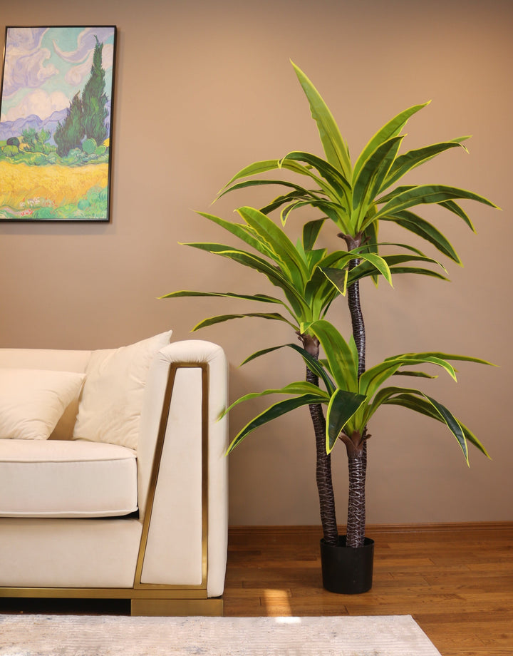 Artificial yucca plant with bold green leaves and yellow accents in a modern black round planter. This realistic faux plant is ideal for contemporary home or office decor, adding a touch of greenery and sophistication