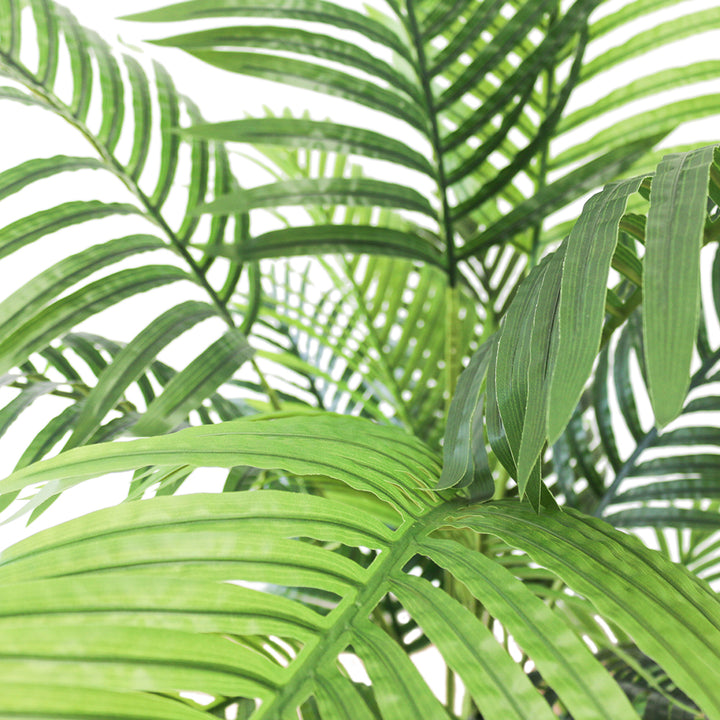 Close-up of artificial palm fronds, showcasing vibrant green leaves and realistic detailing, ideal for indoor decoration.