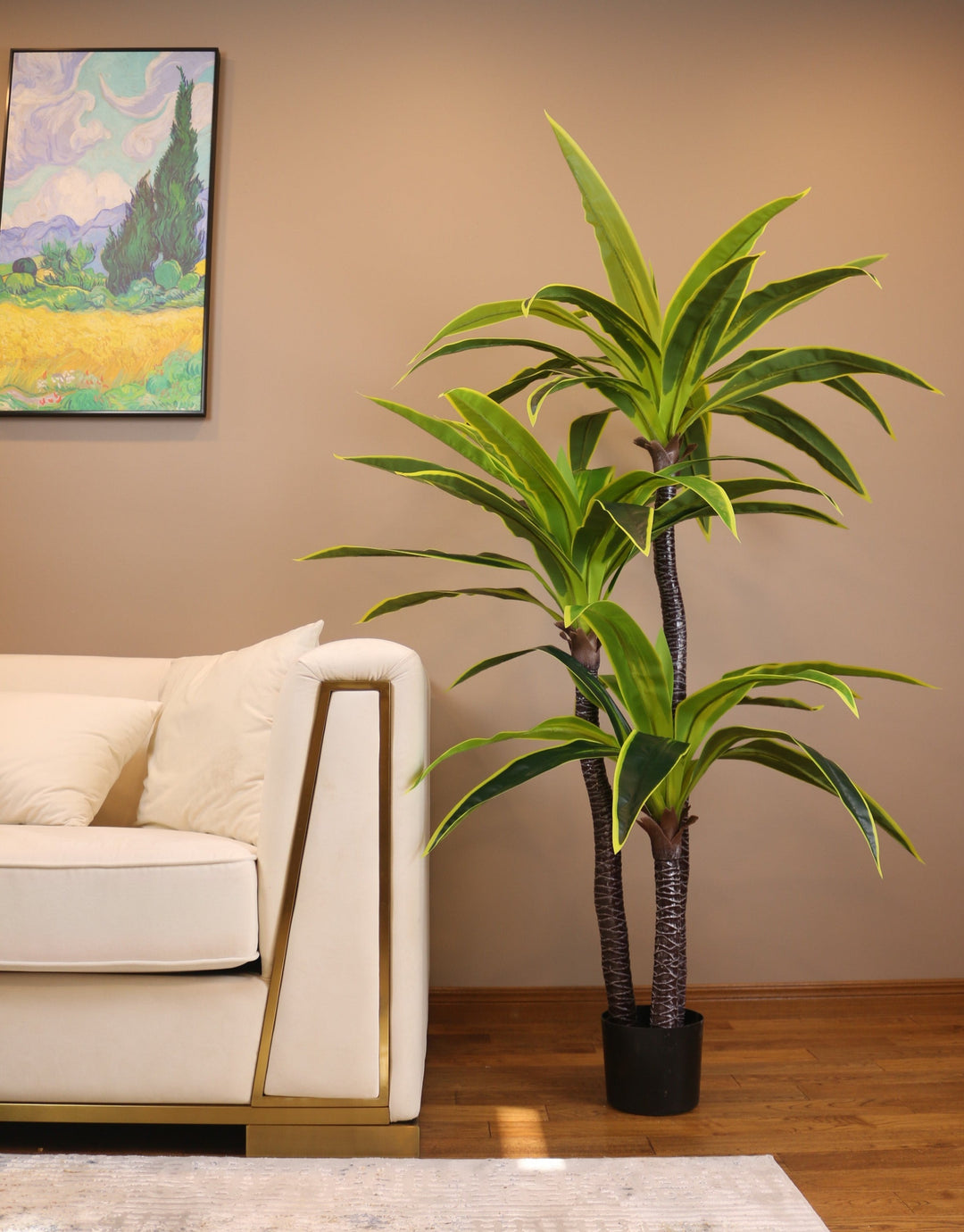 Artificial yucca plant with bold green leaves and yellow accents in a modern black round planter. 